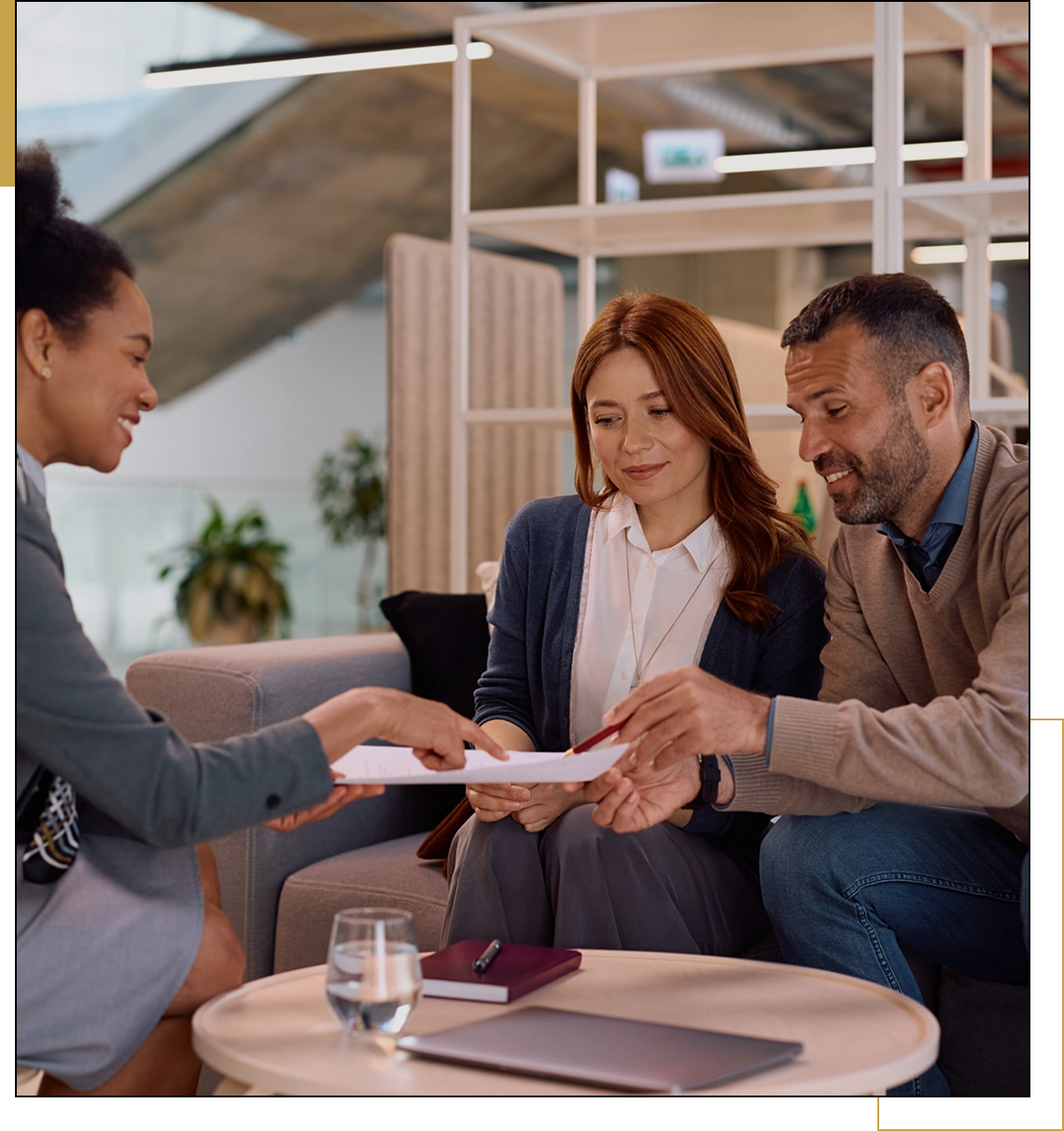 Couple receiving paperwork from advisor
