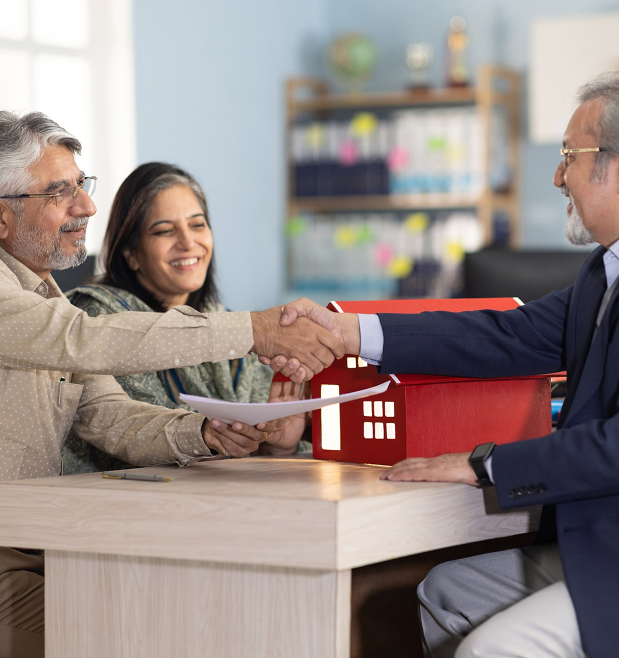 Happy couple finalizing home purchase agreement